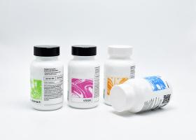 Opaque white glass supplement capsule bottles